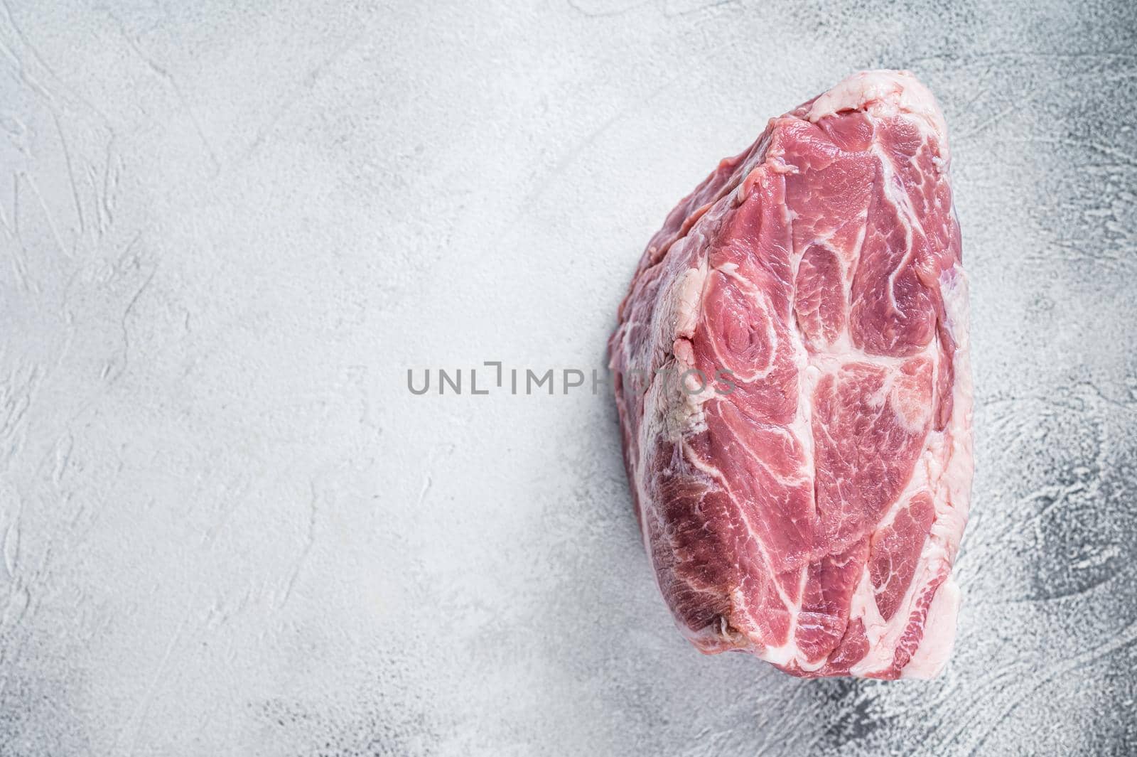 Raw pork neck meat for Chop steak on kichen table. White background. Top view. Copy space by Composter