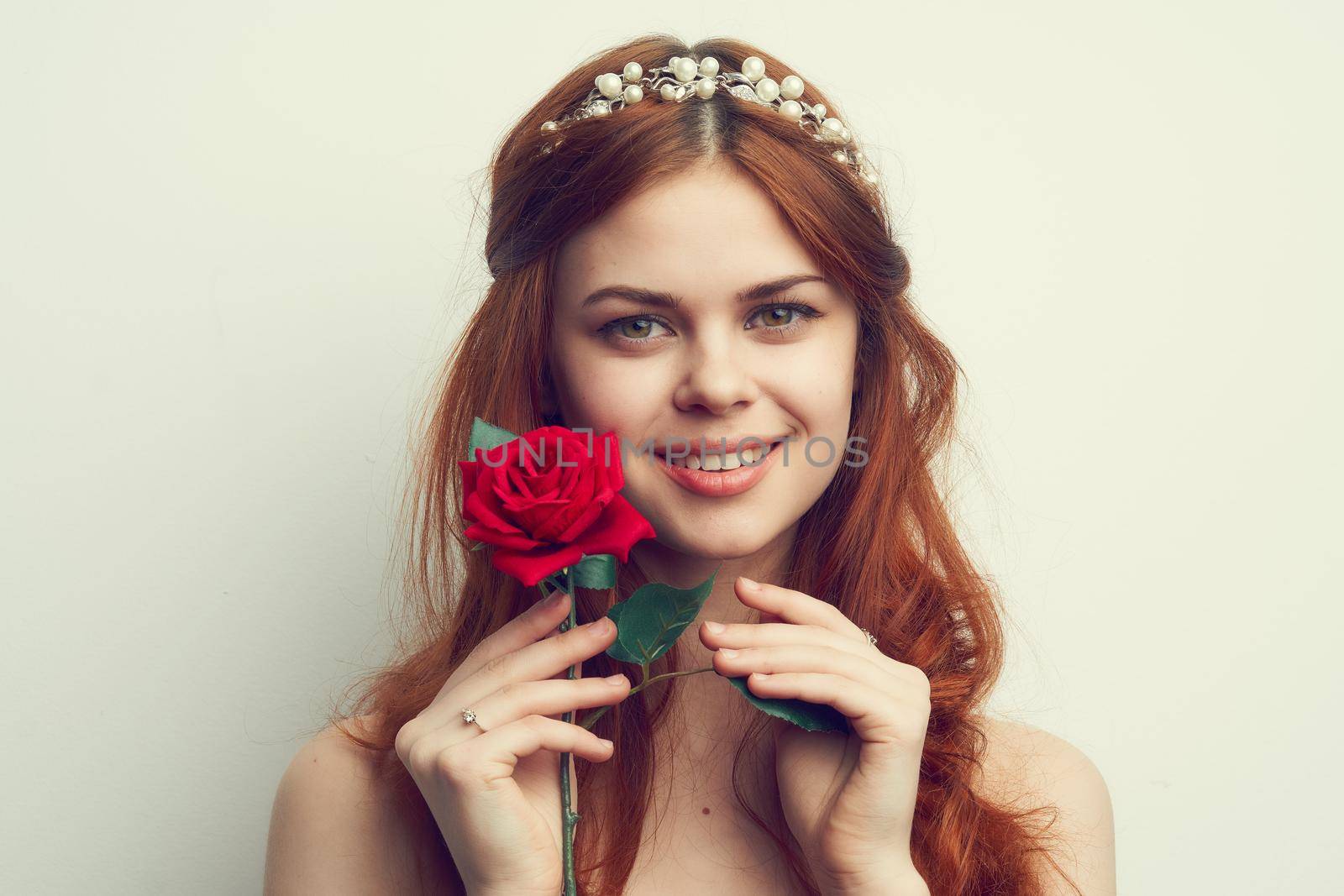 beautiful woman with red hair red rose flower close up. High quality photo