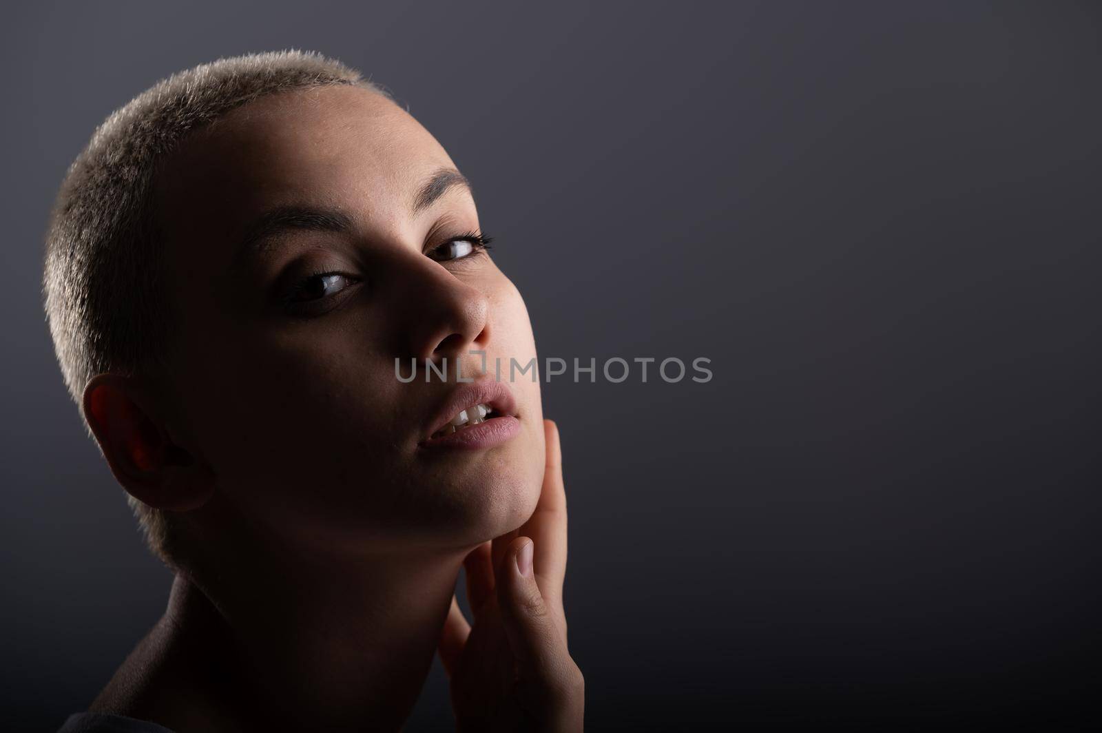 Portrait of pensive young woman with short hair on white background. Copy space.