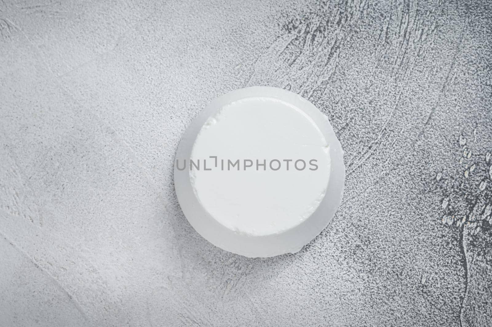 Ricotta cream Cheese on kitchen table. White background. Top view.