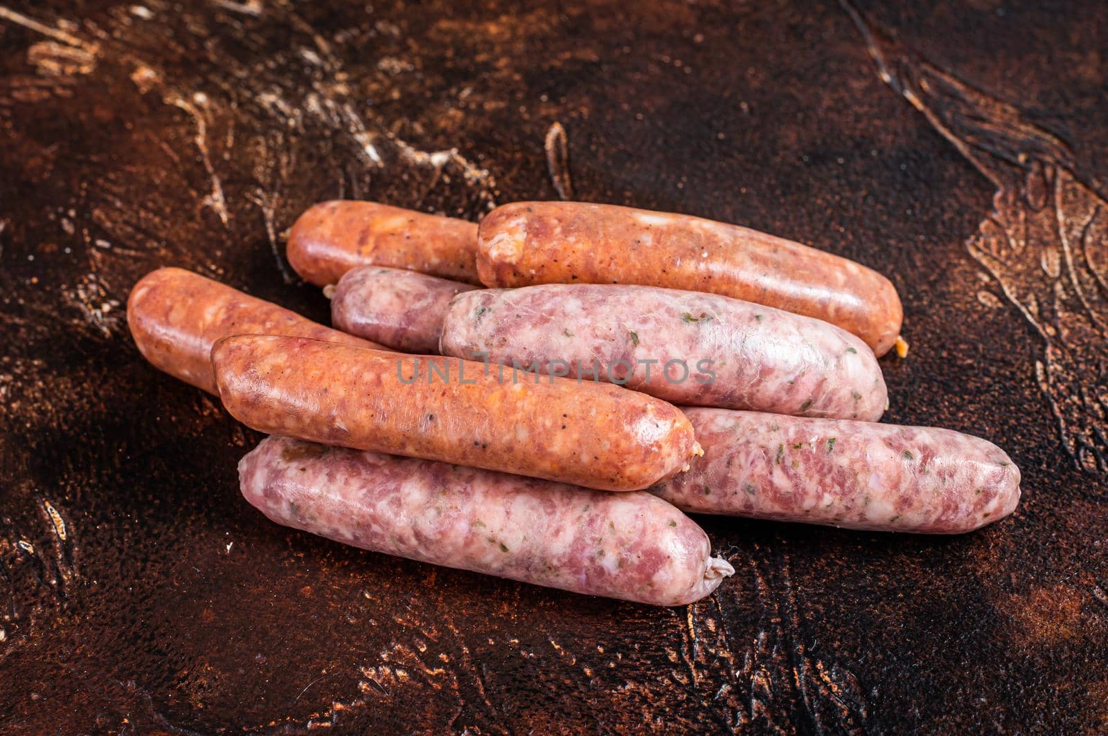 Raw barbecue sausages Chorizo and Bratwurst with spices. Dark background. Top View by Composter