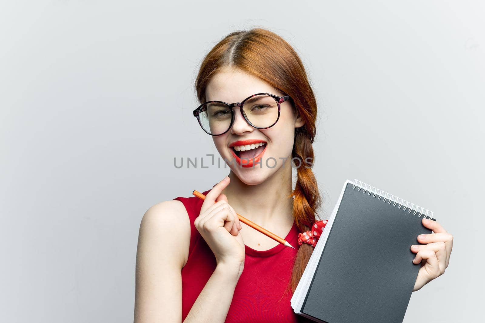 Business woman in red dress notebook pencil professionals. High quality photo