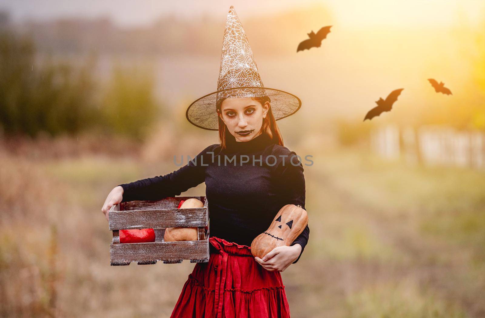 Girl dressed in witch with pumpkins by tan4ikk1