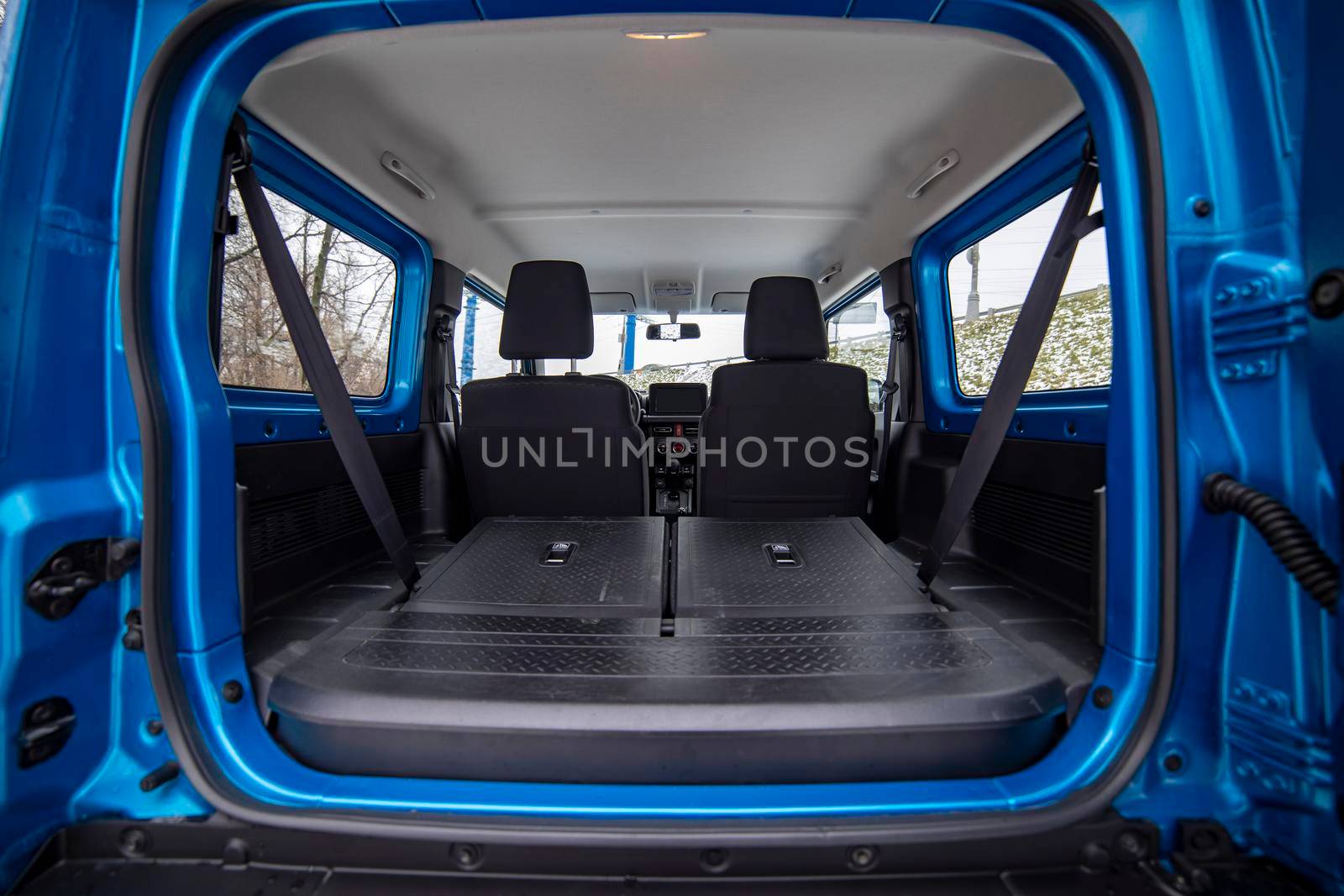 open car trunk with seats folded into a flat flor of suv crossover