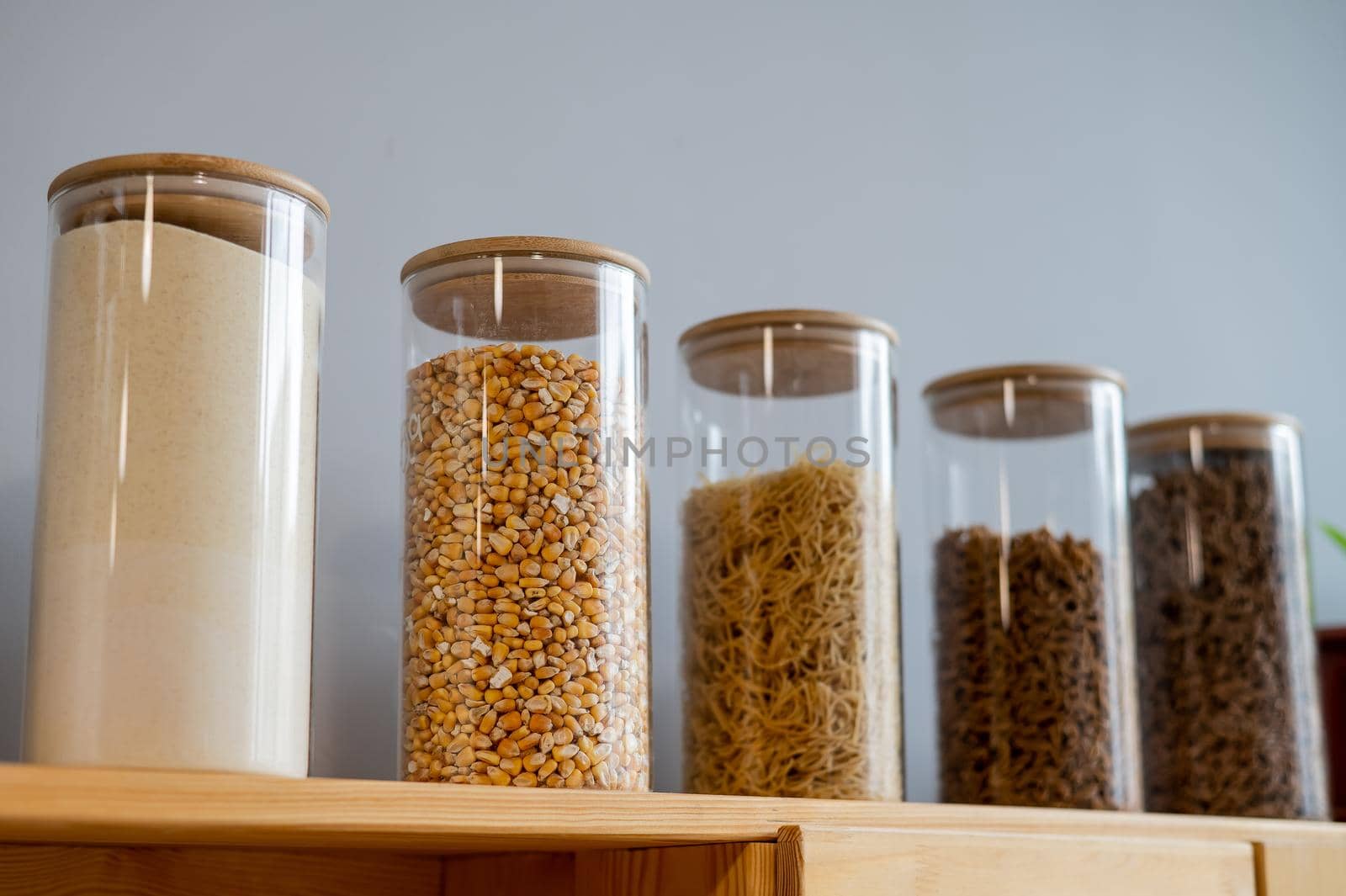 Glass jars with cereals in an eco friendly store. The concept of a grocery store without plastic disposable packaging.