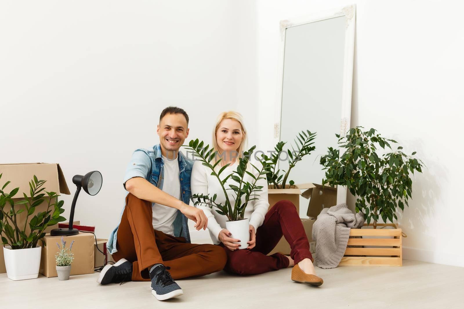 Family unpacking cardboard boxes at new home