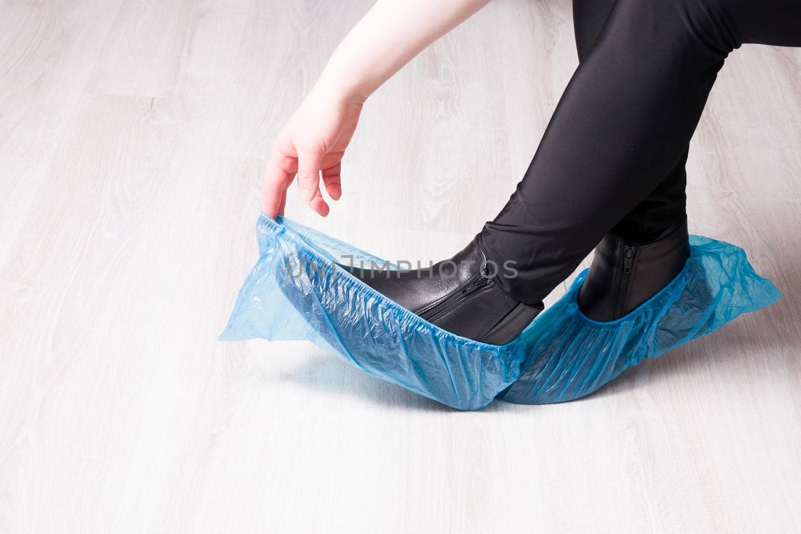 blue disposable shoe covers on a yellow background copy space by natashko