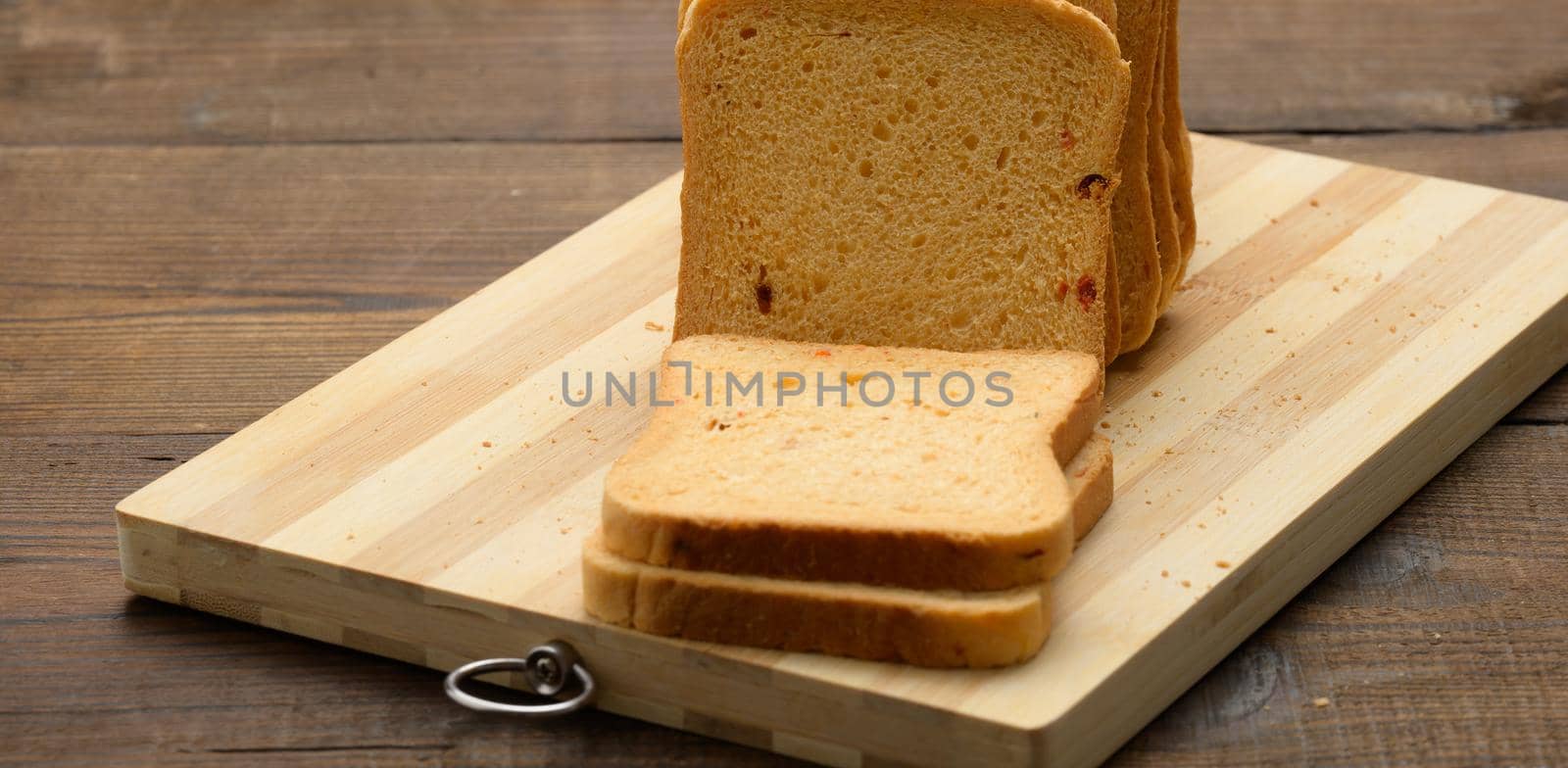 sliced white wheat flour bread on a wooden board. Sandwich bread by ndanko