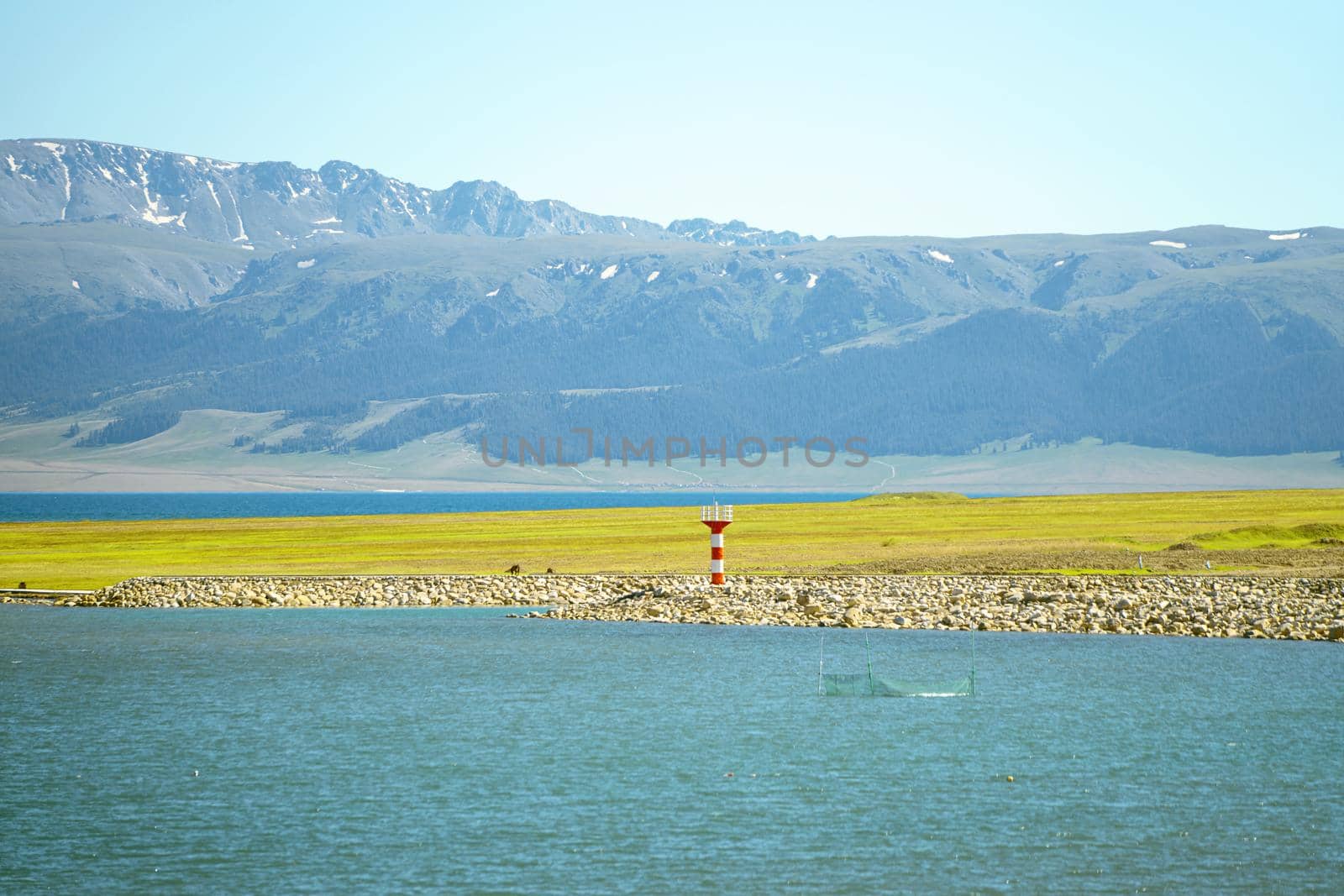 Road and lighthouses on the lake. Shot in Sayram Lake, Xinjiang, China.