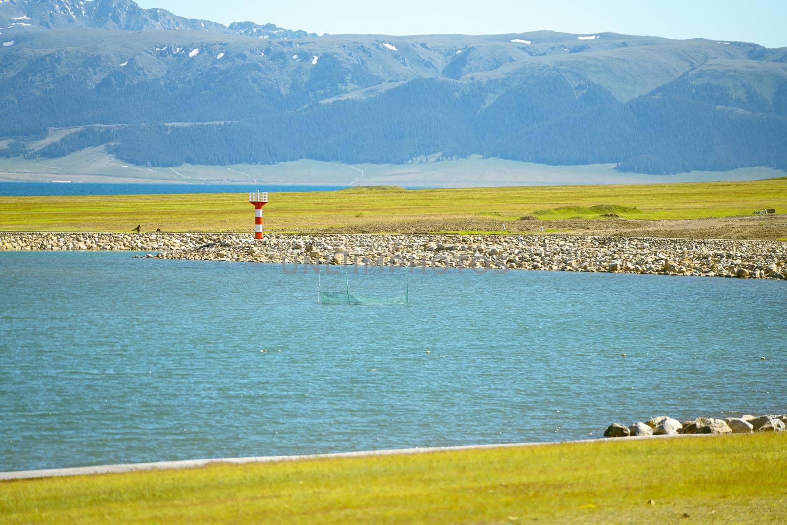 Road and lighthouses on the lake. Shot in Sayram Lake, Xinjiang, China.