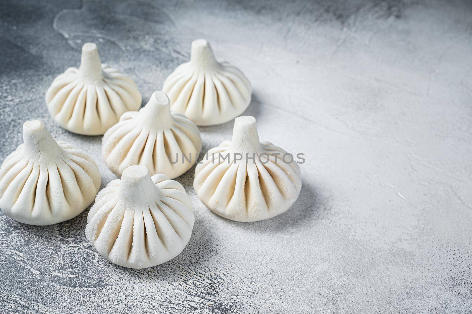 Georgian Raw dumpling Khinkali with meat. White background. Top view. Copy space by Composter