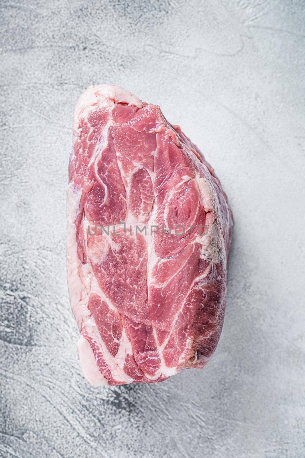 Raw pork neck meat for Chop steak on kichen table. White background. Top view by Composter