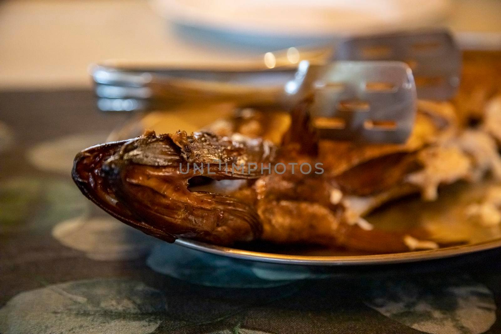 delicious smoked fish on a plate. close-up, selective focus, blurred background. dinner at reasaurant