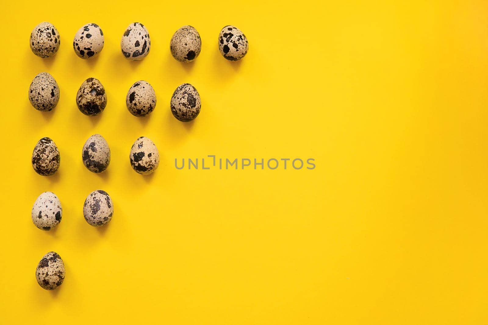 Quail Easter eggs on yellow background. Easter elements. Easter background. Easter pattern. Top view. Flat lay. Minimal concept. by Annu1tochka