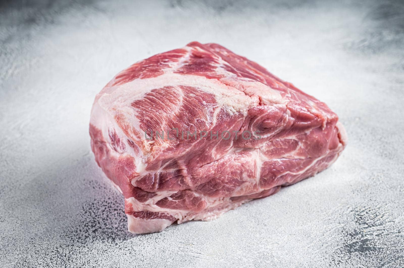 Raw pork neck meat for Chop steak on kichen table. White background. Top view.