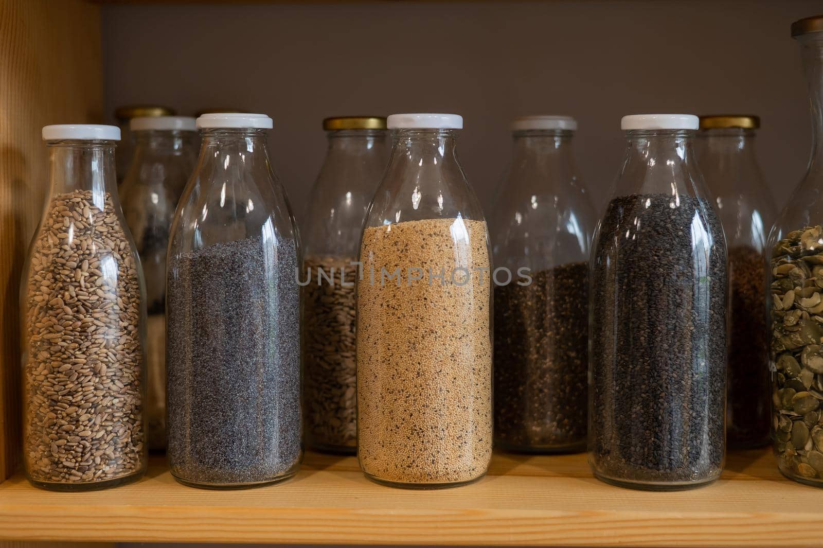 Glass jars with cereals in an eco friendly store. The concept of a grocery store without plastic disposable packaging.