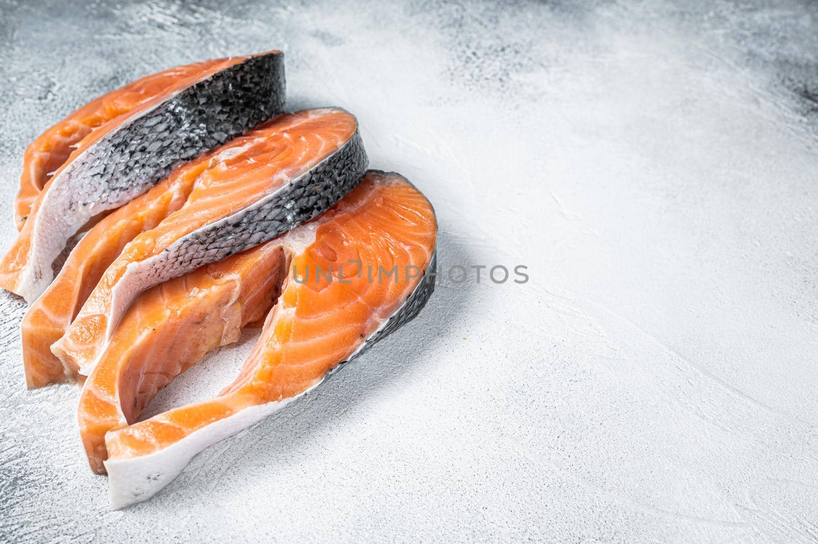 Salmon or trout steaks, raw fish prepared for cooking. White background. Top view. Copy space.