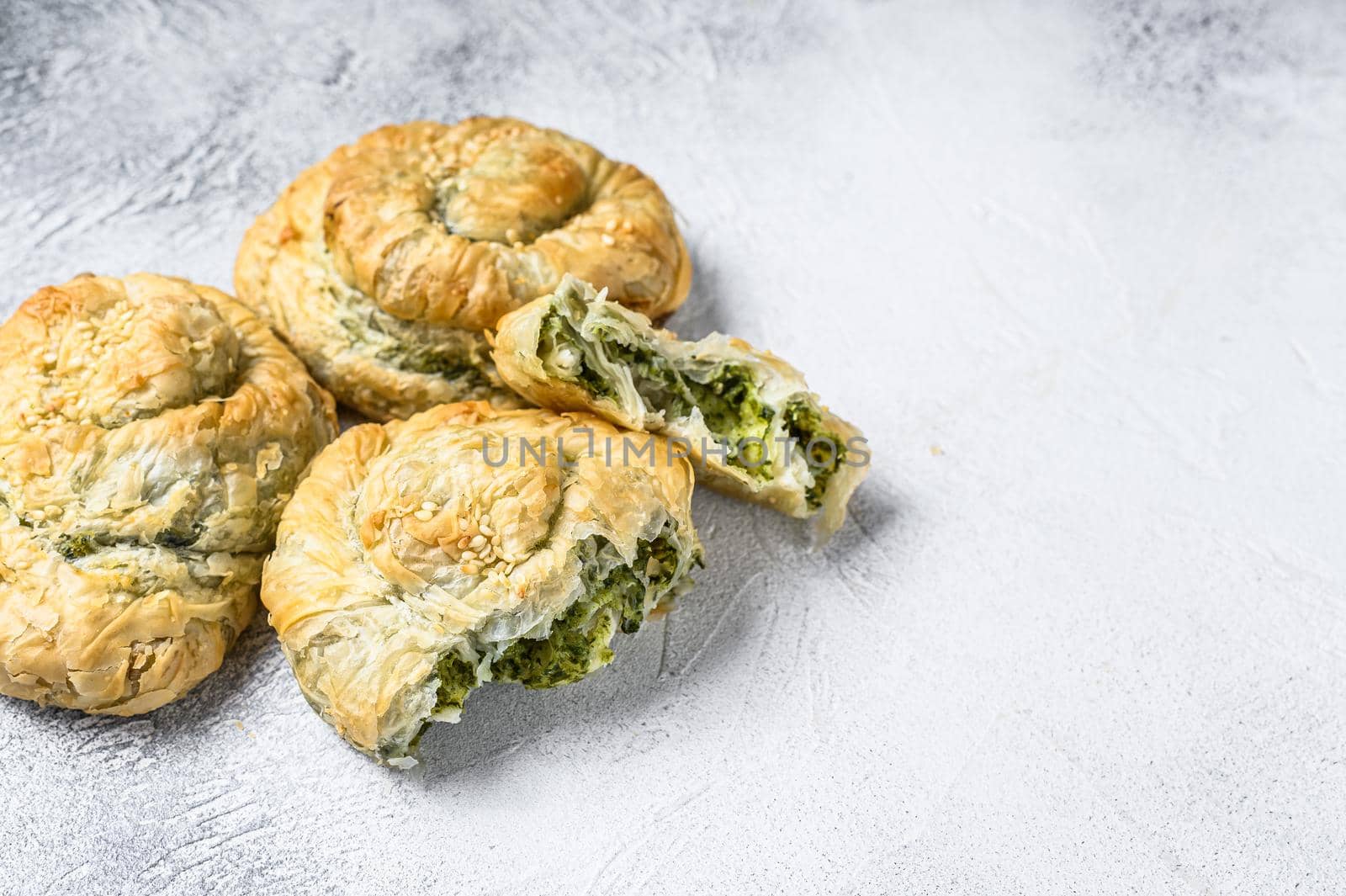 Spinach and feta cheese Twist greek Pie puff. White background. Top view. Copy space.