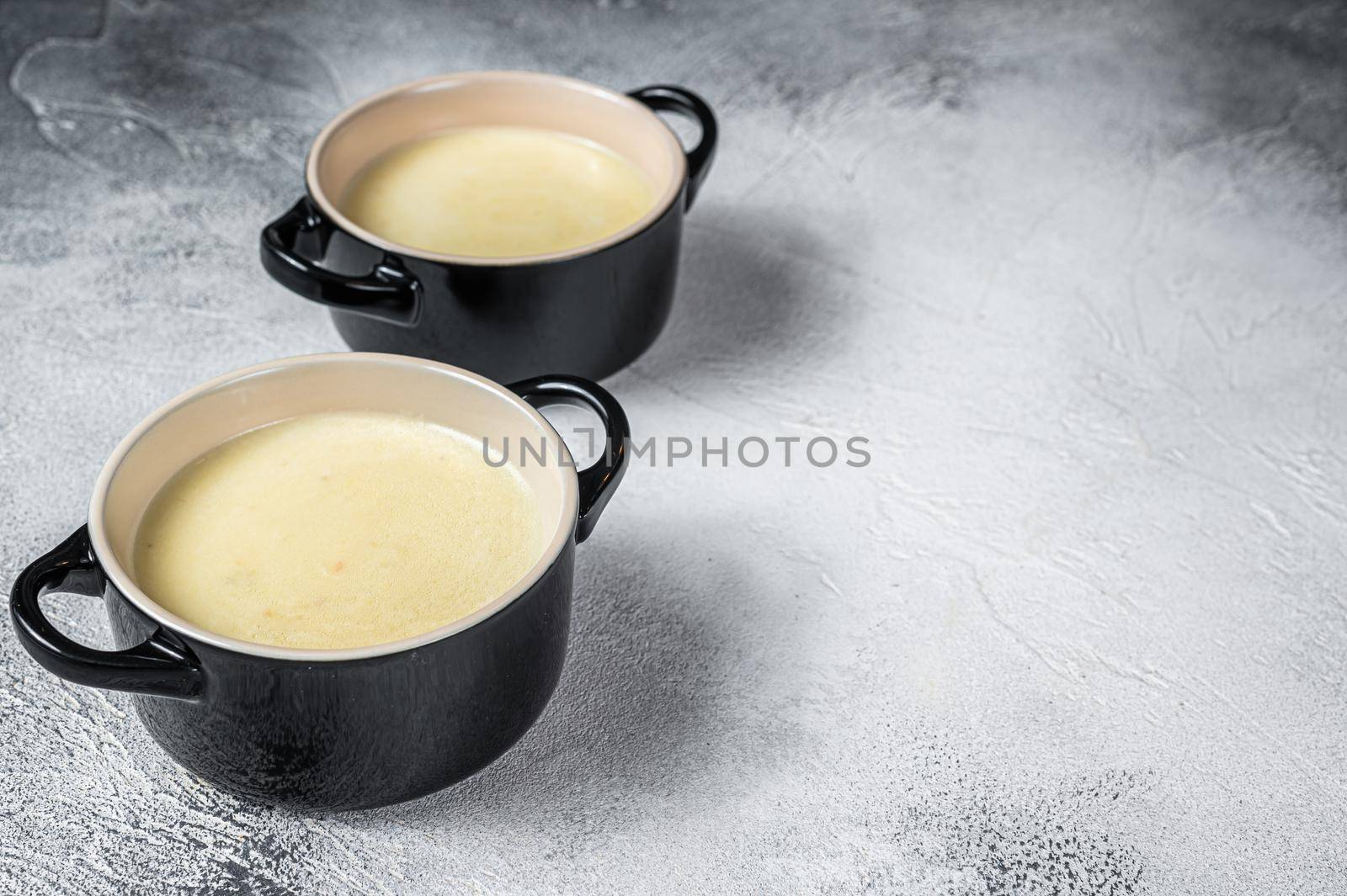 Homemade potato cream soup in bowls. White background. Top view. Copy space by Composter