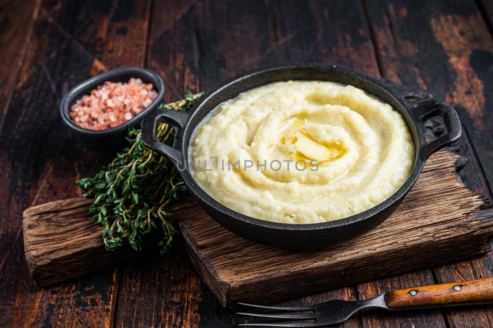 Mashed potatoes in a pan on wooden rustic table. Wooden background. Top view.