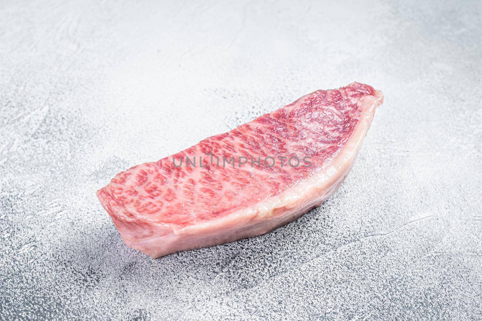 Raw wagyu rump sirloin steak, kobe beef meat. White background. Top view by Composter