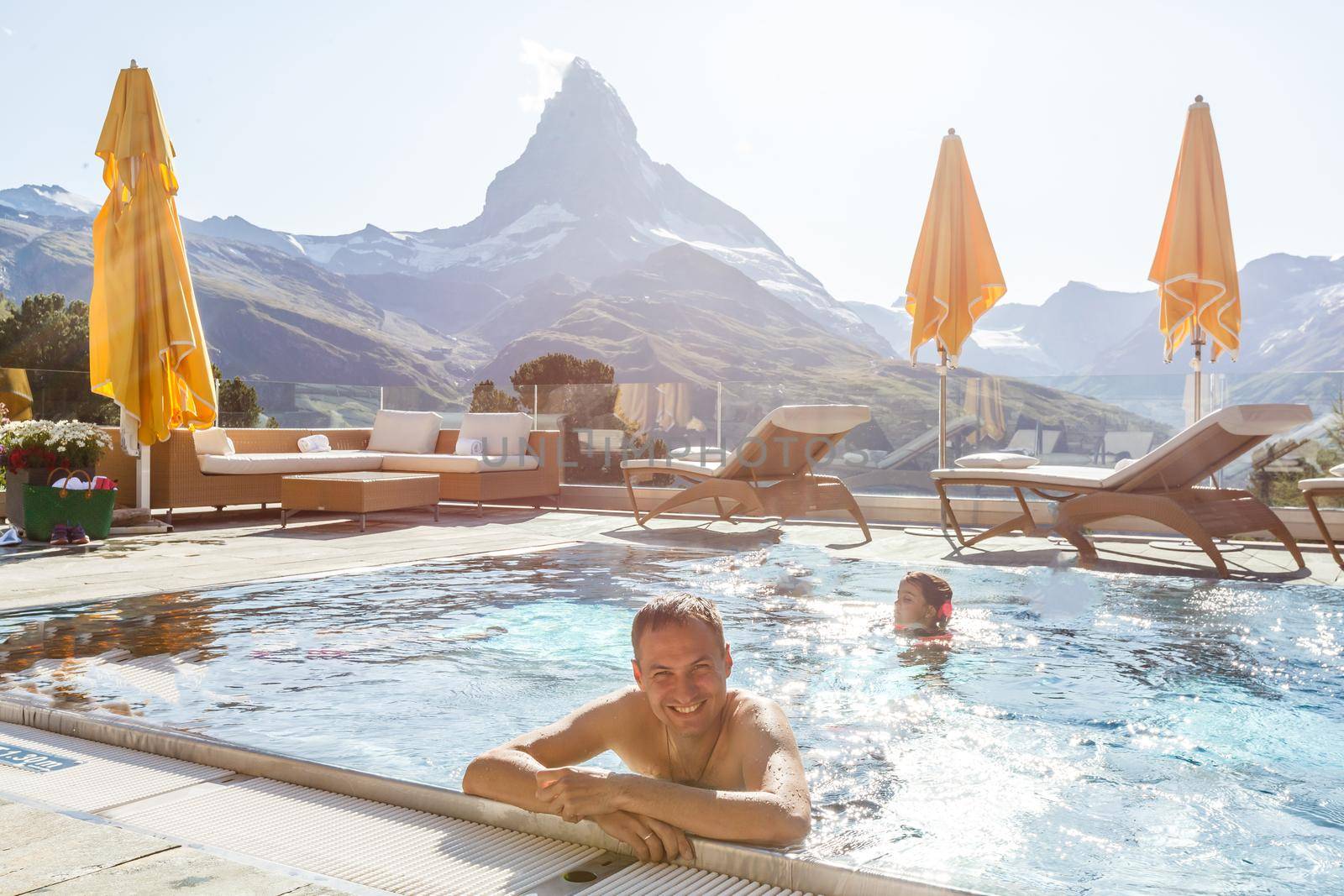 Young man chilling on a open terrace in the SPA with an amazing mountains
