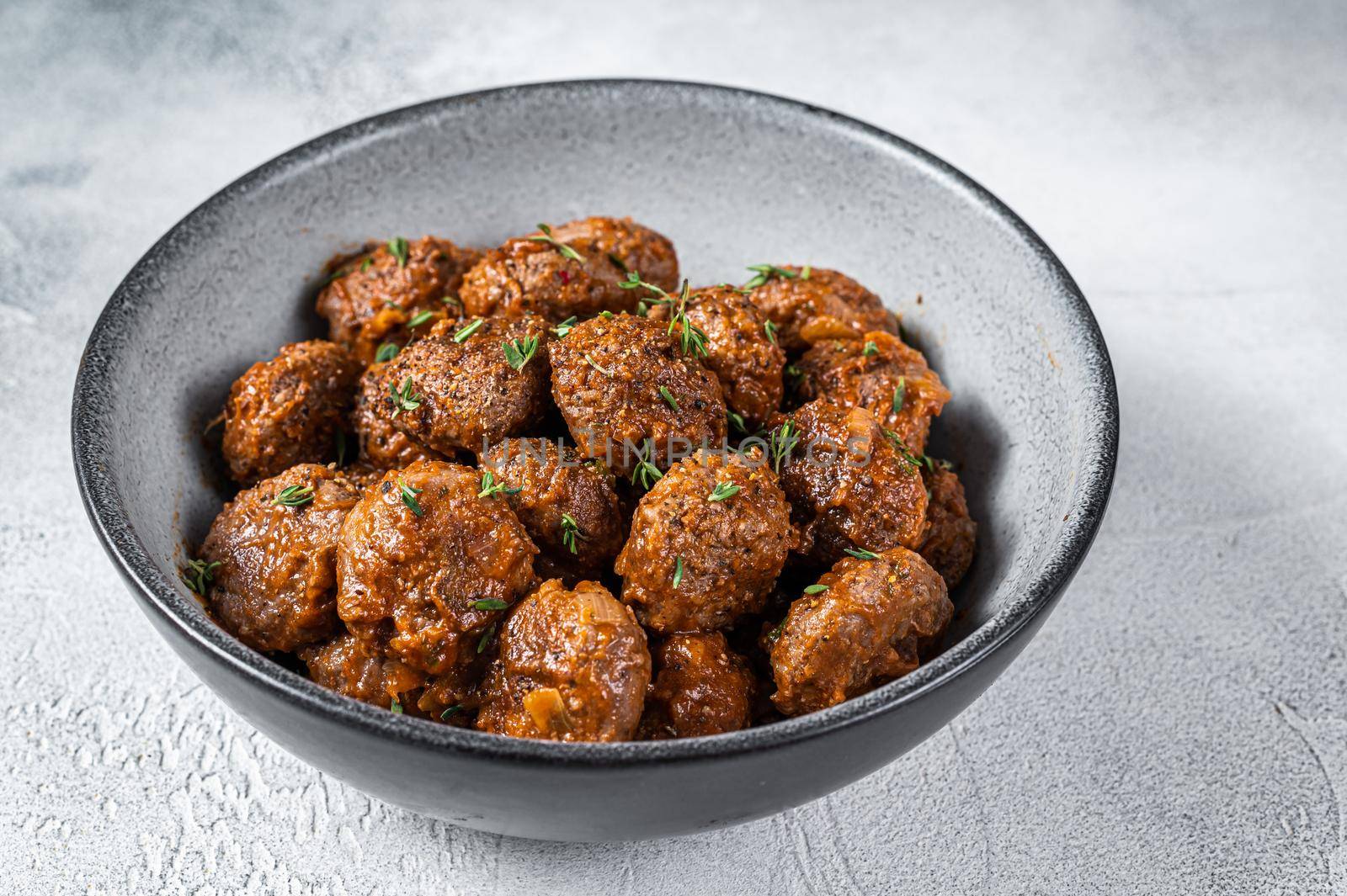 Fried Meatballs in tomato sauce from ground beef and pork meat. White background. Top view by Composter