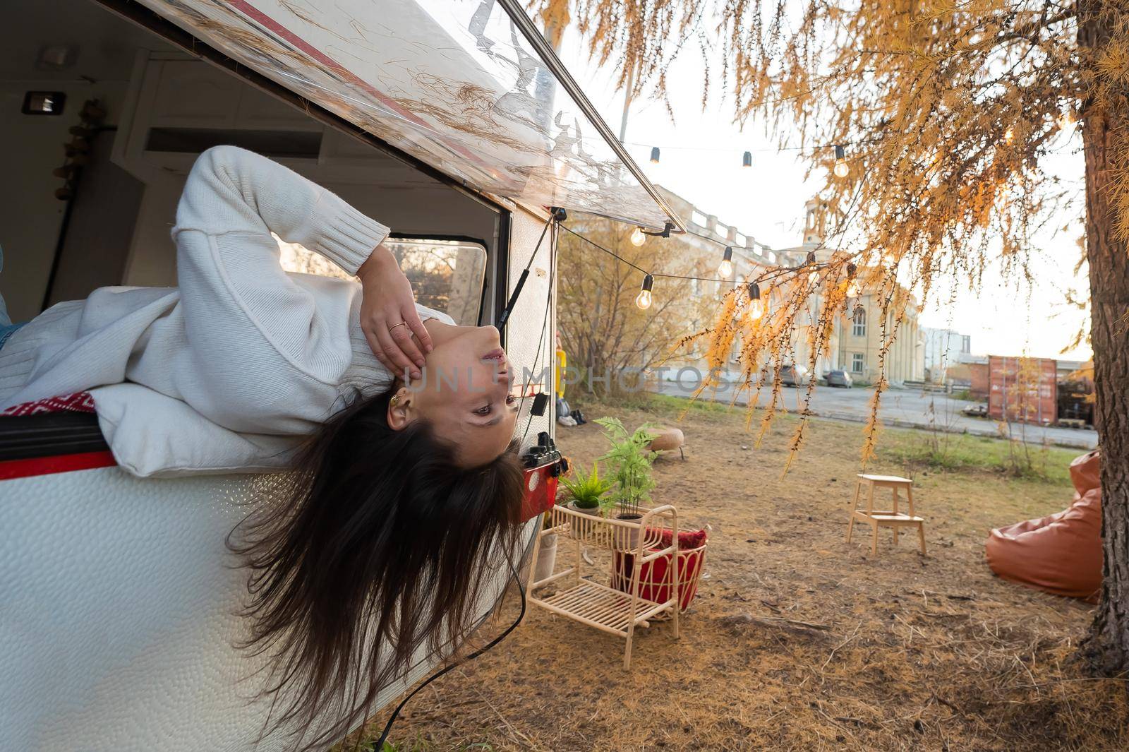 Caucasian woman peeking out of camper window