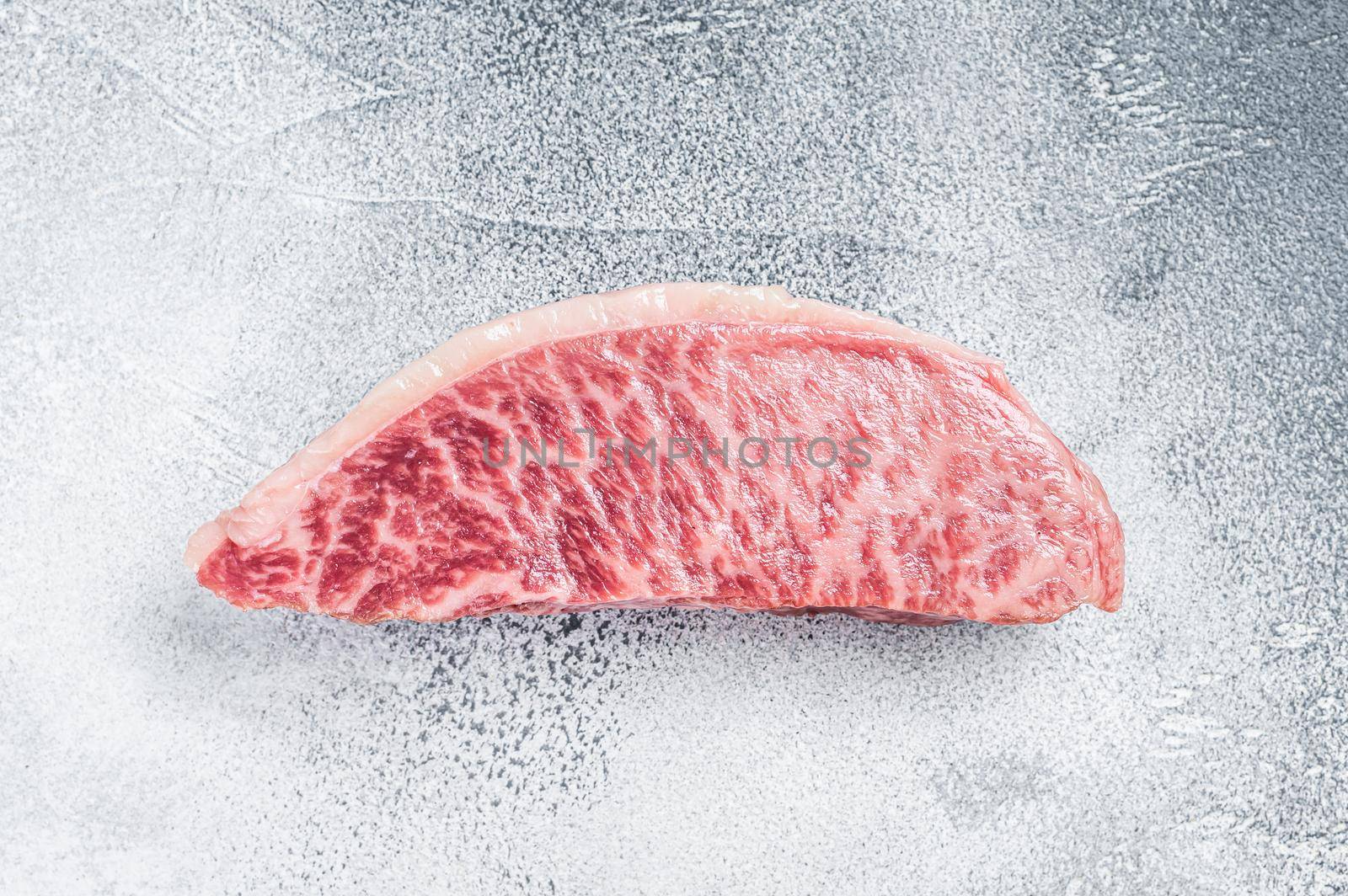 Raw wagyu rump sirloin steak, kobe beef meat. White background. Top view by Composter