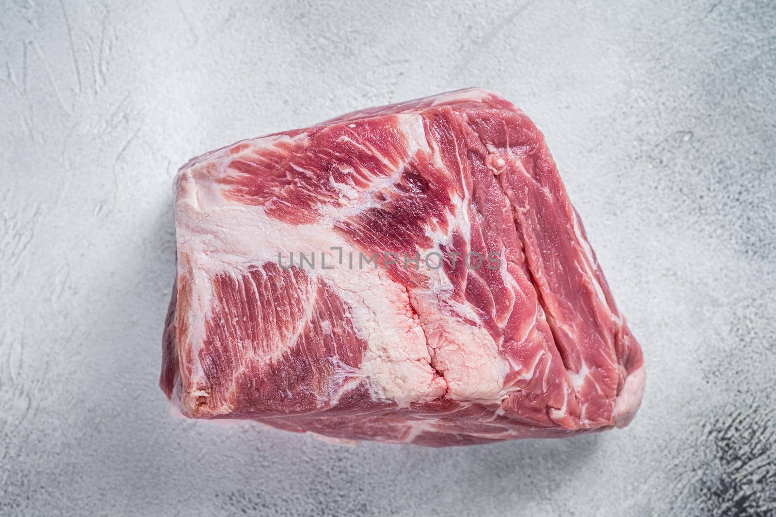 Raw pork neck meat for Chop steak on kichen table. White background. Top view by Composter