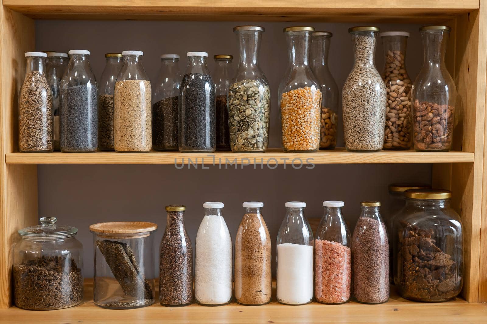 Glass jars with cereals in an eco friendly store. The concept of a grocery store without plastic disposable packaging.