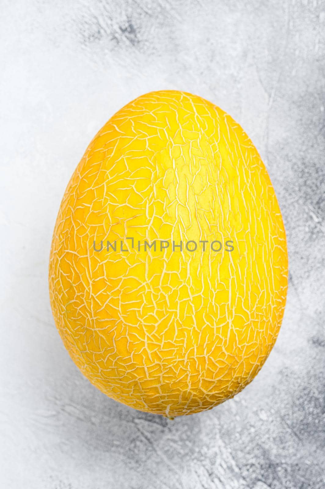 Whole yellow ripe melon. White background. Top view by Composter