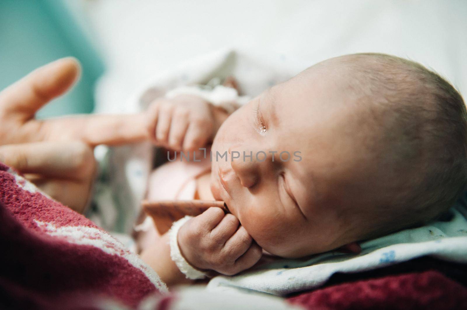 Maternity and parenting. child holds mother by the finger with his small pen.