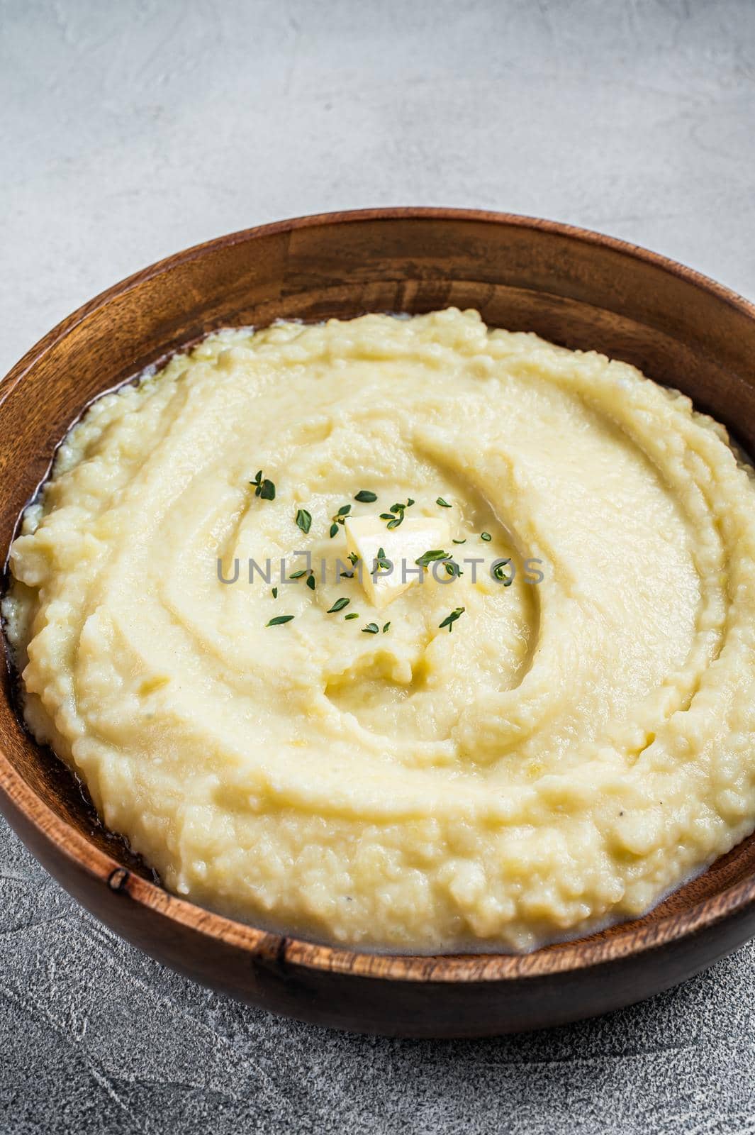 Boiled potato puree, Mashed potatoes in a wooden plate. White background. Top view.
