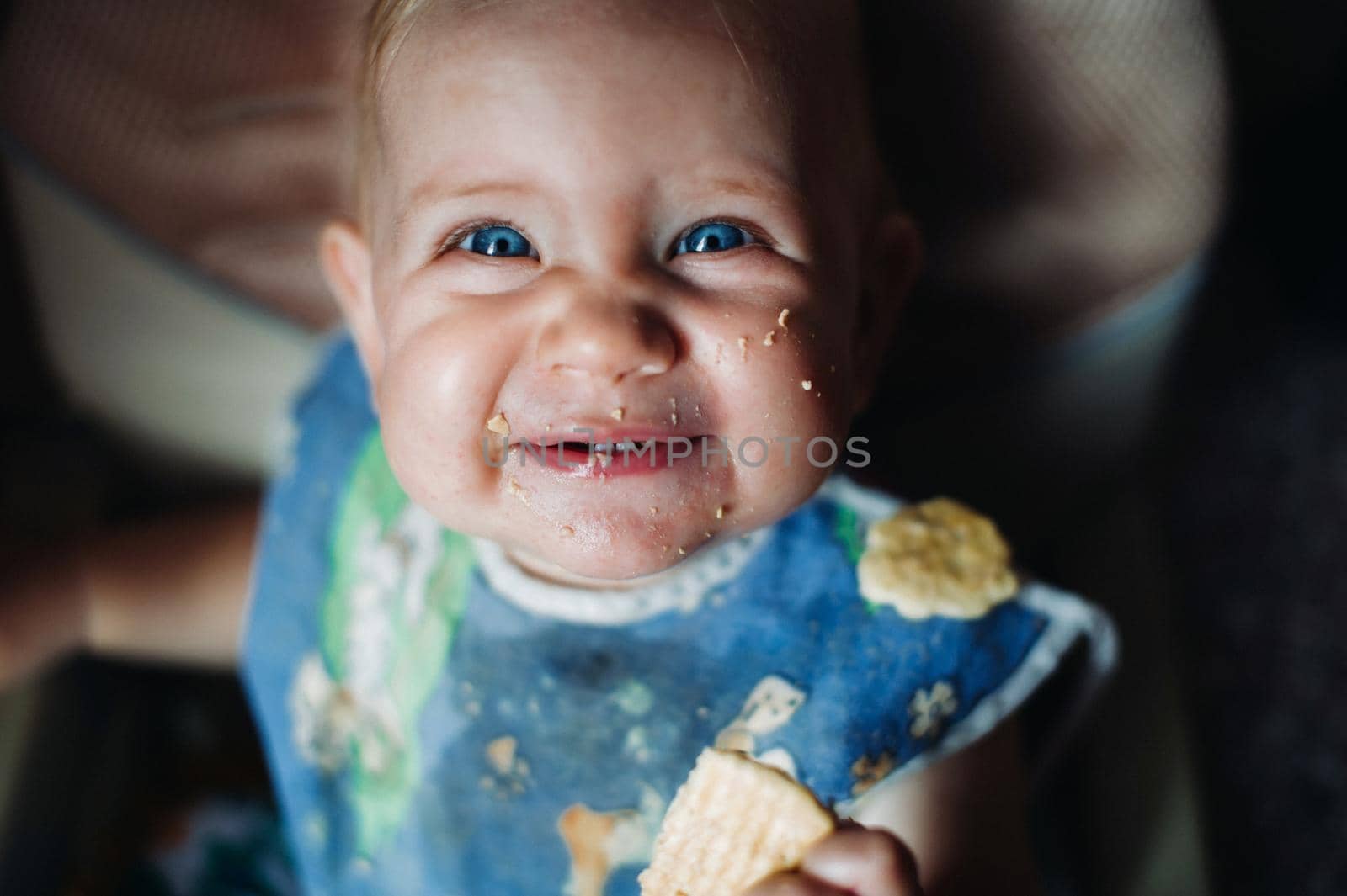 cute little girl eating sweet cookies and smiling.