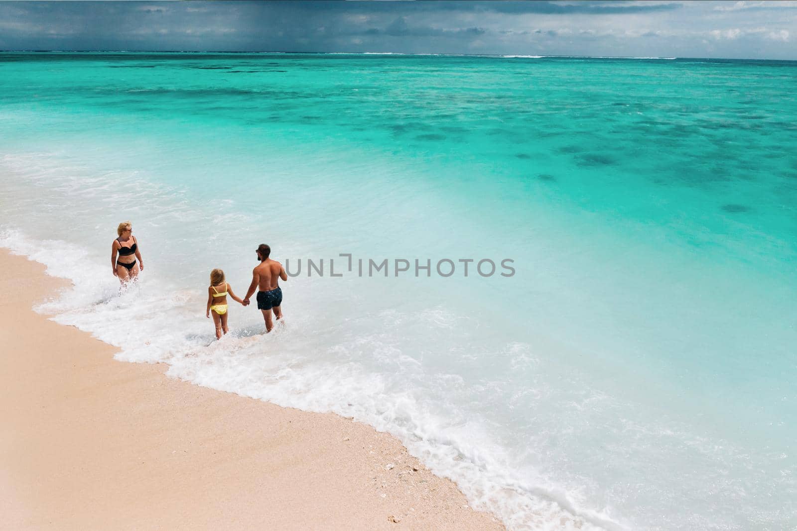 Young beautiful family with a child on a tropical vacation.mauritius island by Lobachad