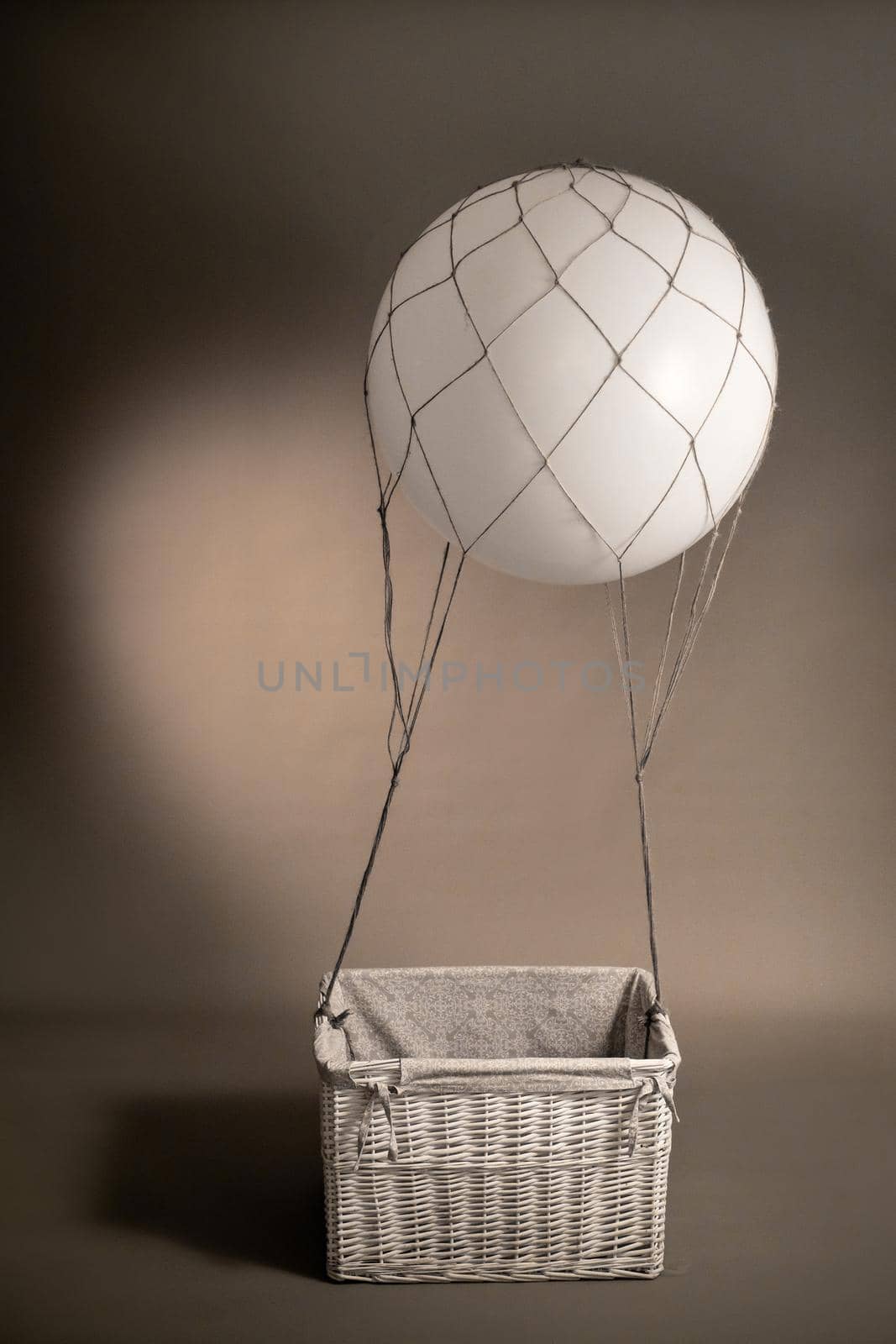 Balloon pilot for flying toy on gray background.