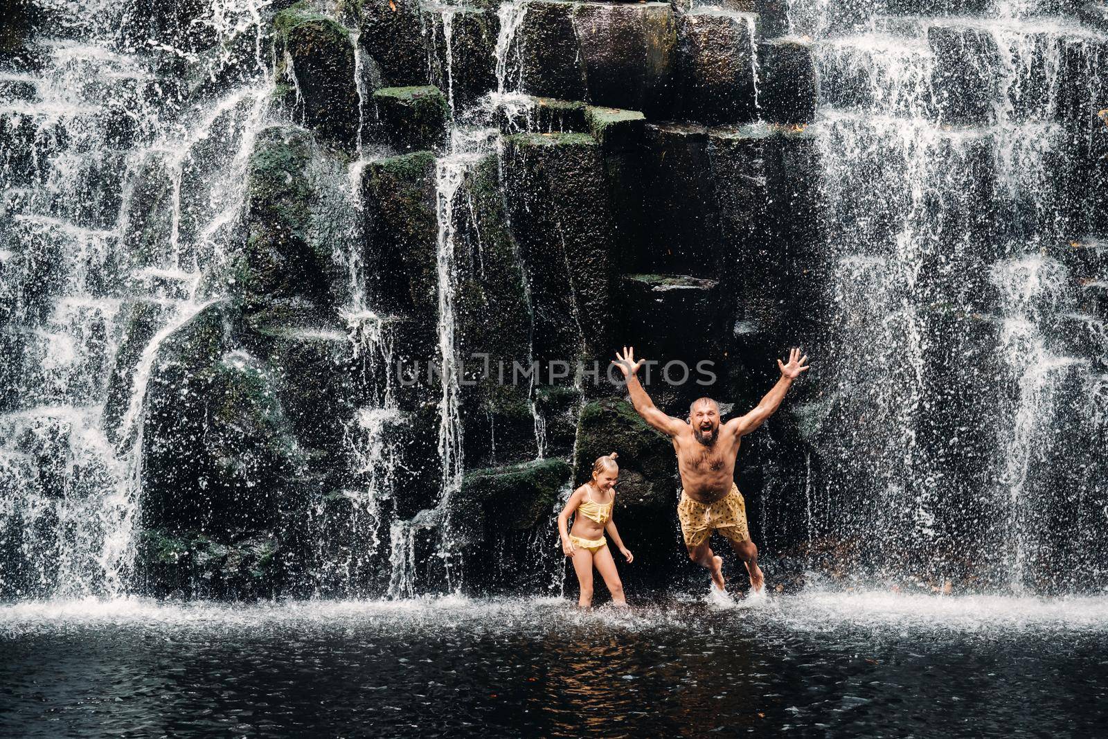 Many people bathe in a waterfall. People at the cave waterfall. Bathing. by Lobachad