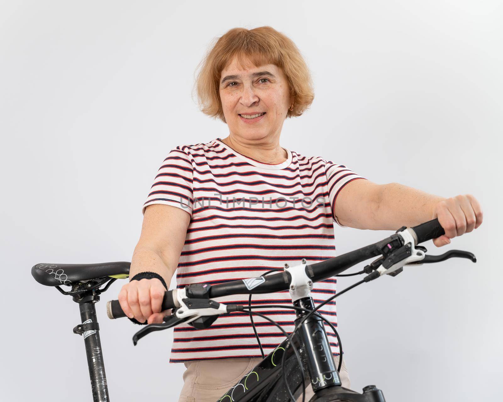 Elderly woman on a bicycle on a white background. by mrwed54