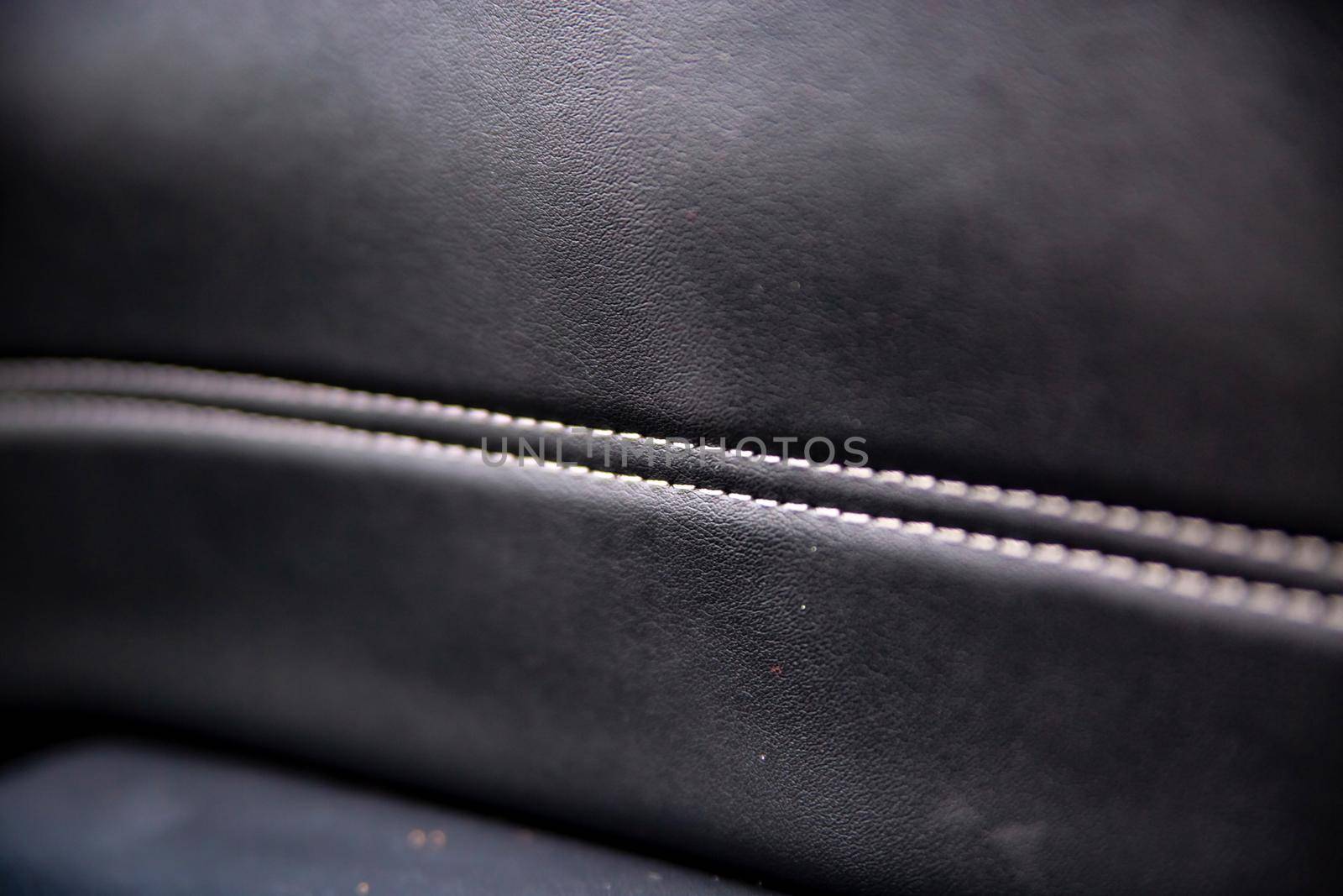 white trim on the black leather interior of a premium modern car. close-up. selective focus by Mariaprovector