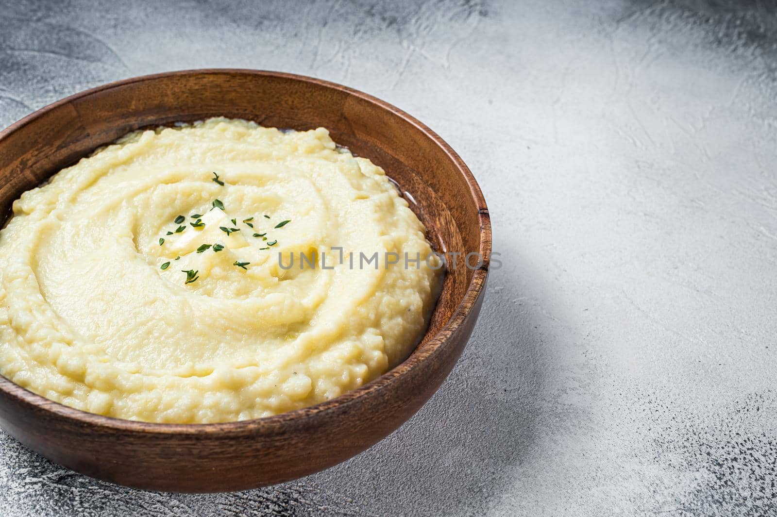 Boiled potato puree, Mashed potatoes in a wooden plate. White background. Top view. Copy space by Composter