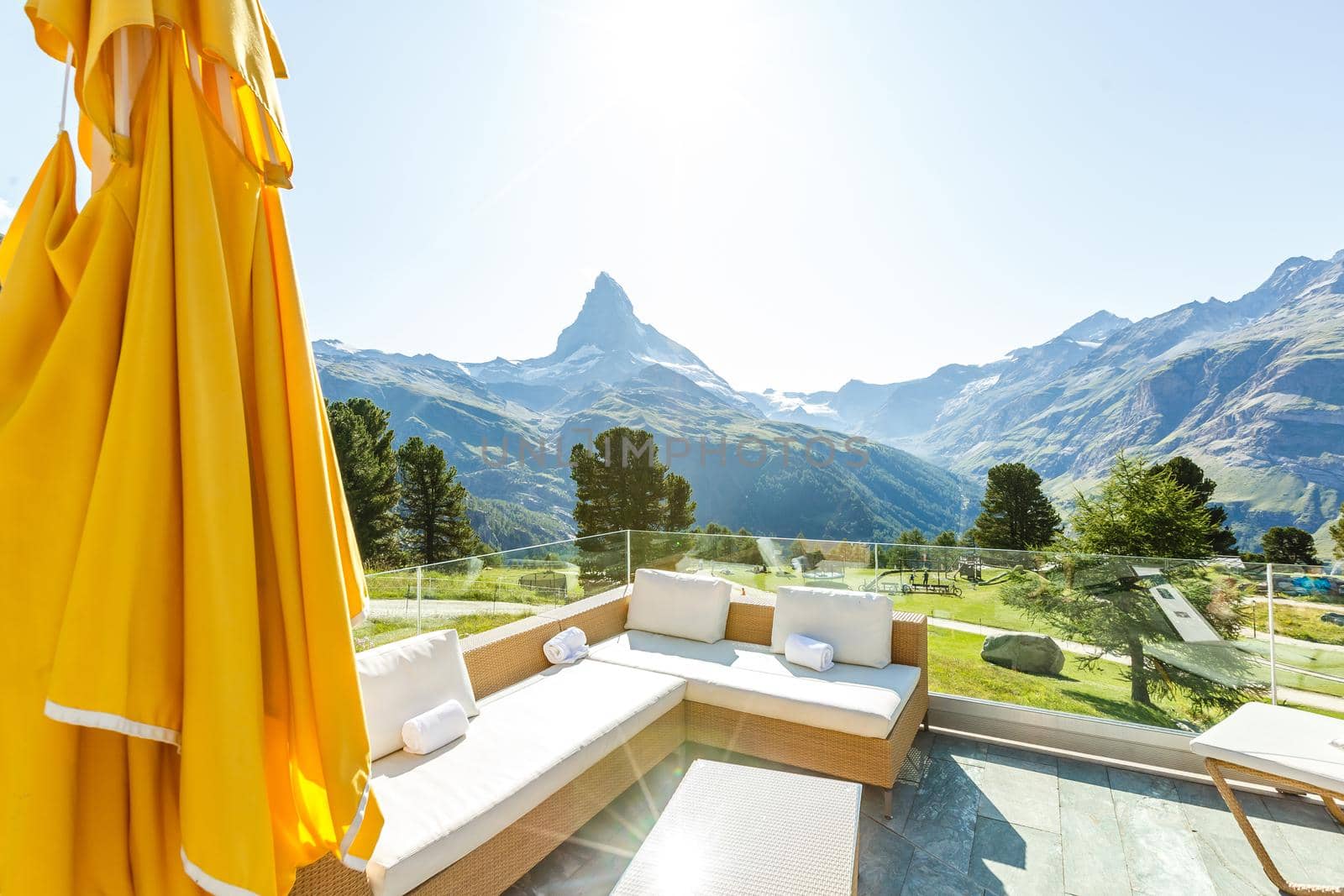 Sunny summer morning in Zermatt village with Matterhorn peak on backgroud. Beautiful outdoor scene in Swiss Alps, Switzerland, Europe.