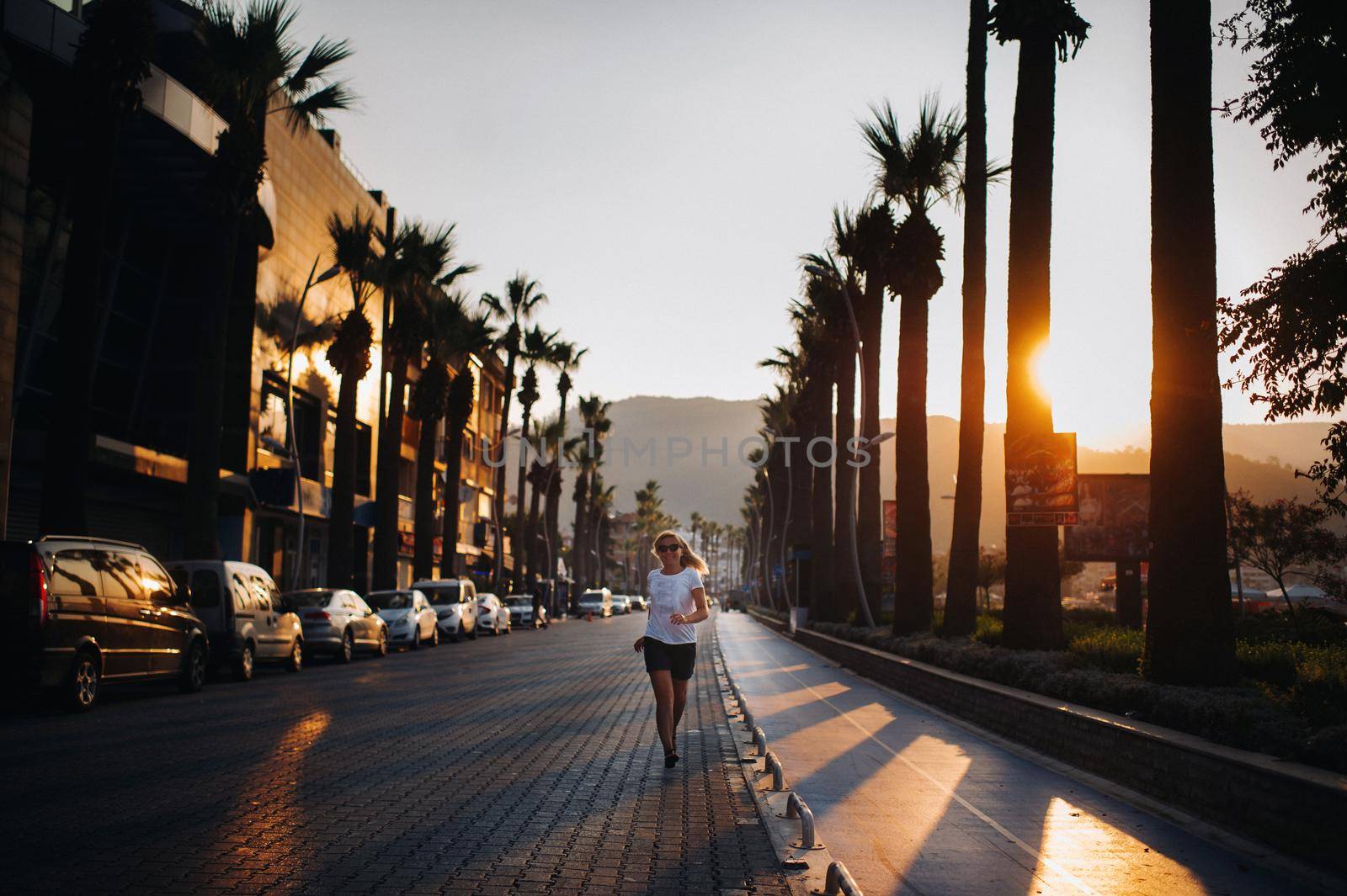 morning run of a young woman along the promenade.