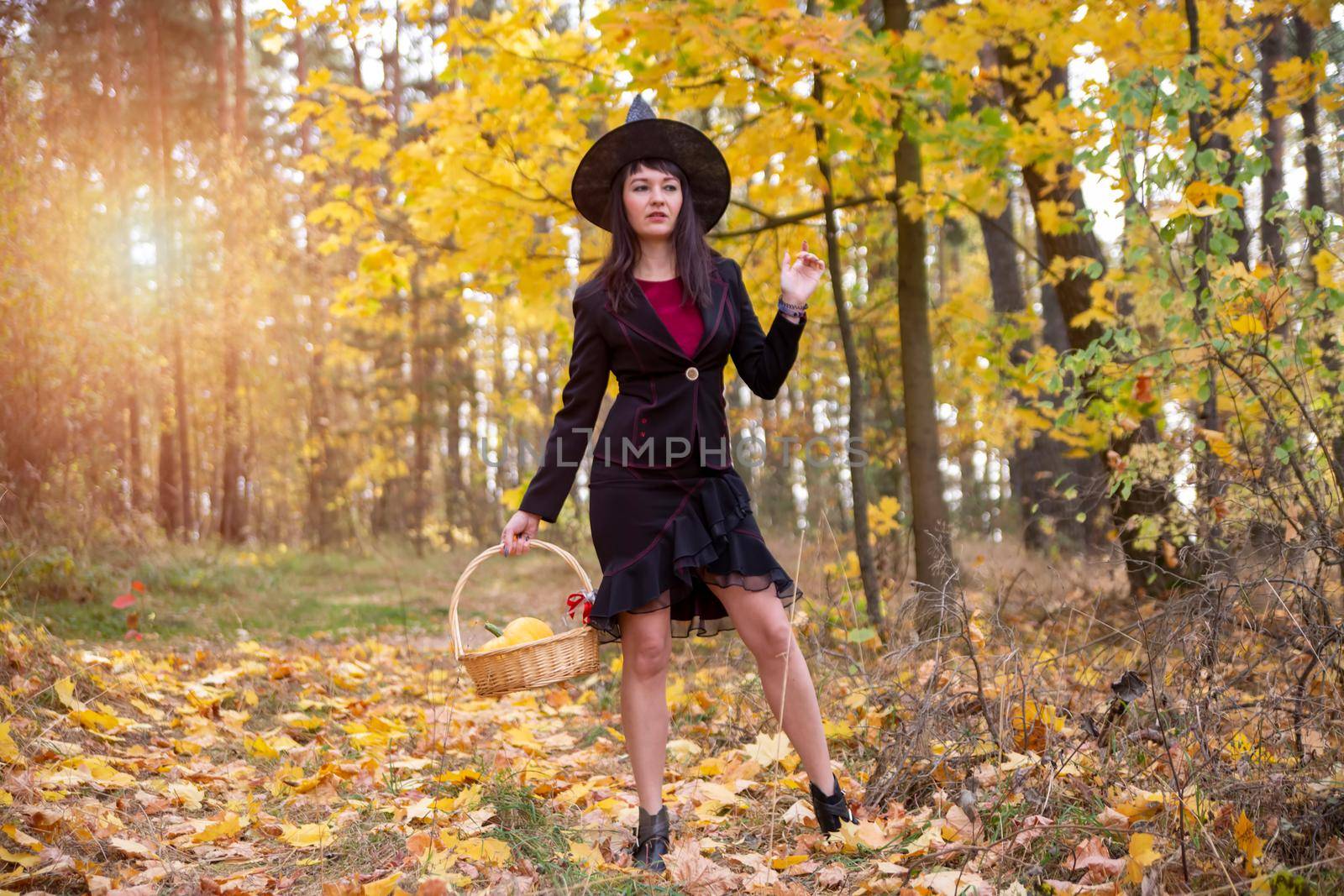witch in the autumn forest. halloween cosplay. halloween fall holiday celebration by Mariaprovector