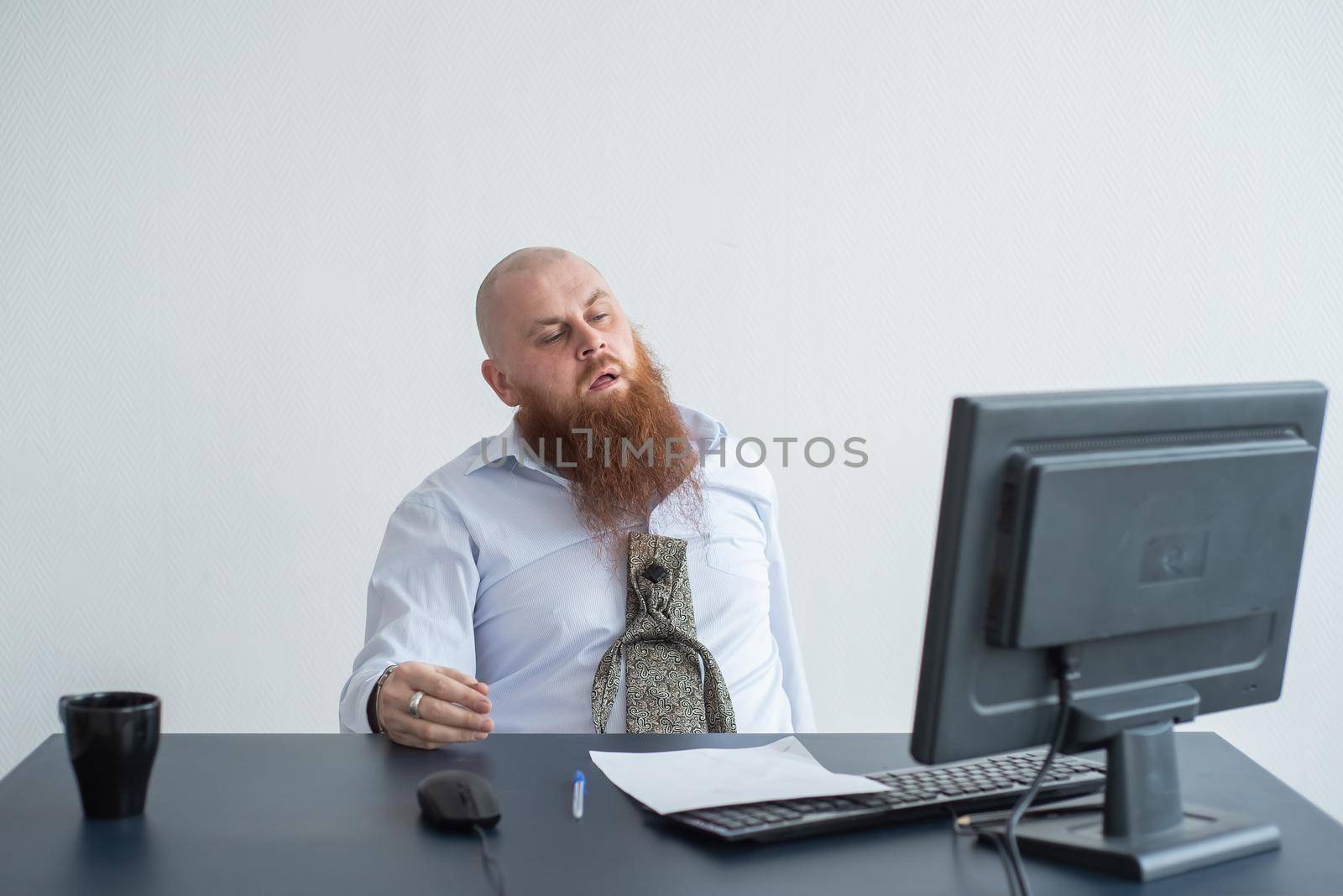 Problems for the office worker. A bald man in a white shirt sits at a desk with a computer and is stressed because of failure. A nervous breakdown. by mrwed54