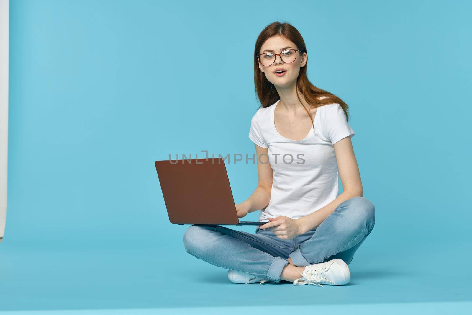 woman sitting on the floor with laptop student education online. High quality photo