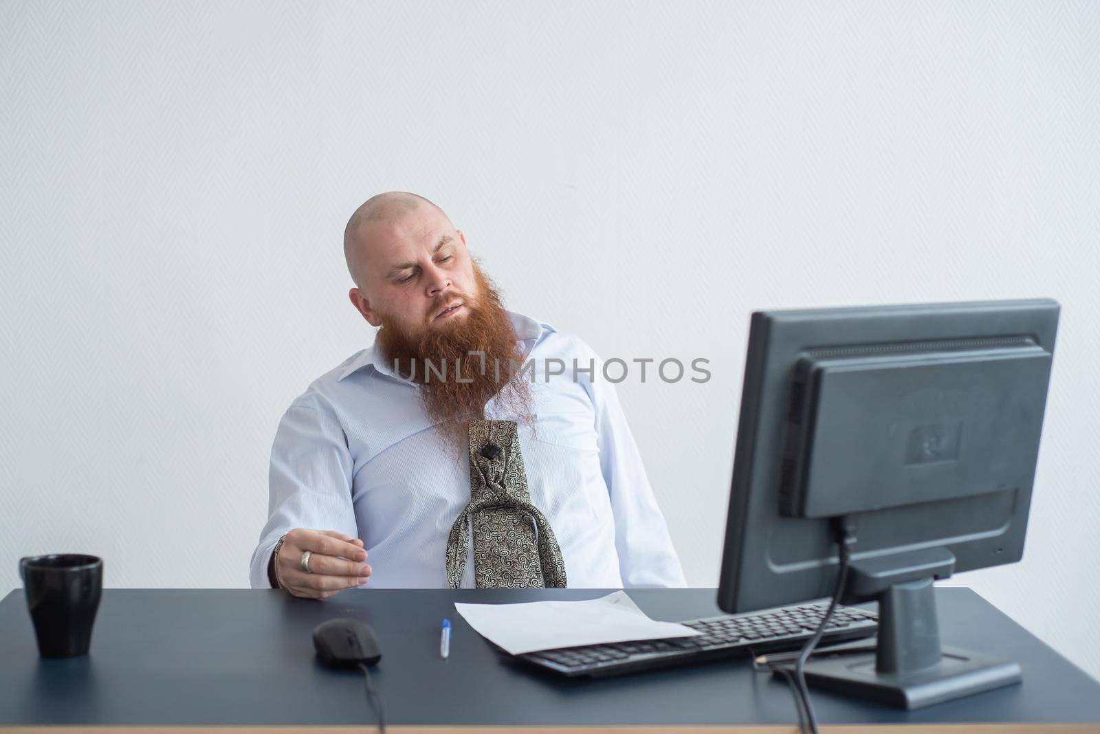 Problems for the office worker. A bald man in a white shirt sits at a desk with a computer and is stressed because of failure. A nervous breakdown. by mrwed54