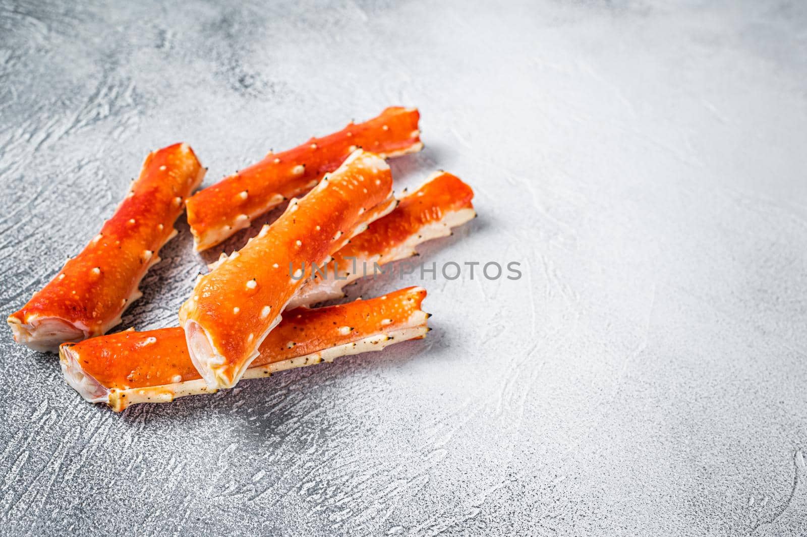 Crab legs Phalanx on a kitchen table. White background. Top view. Copy space.