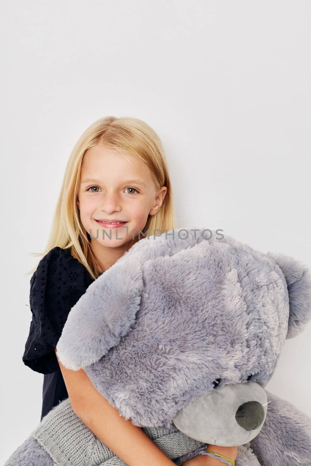happy child in a black t-shirt grimace on a light background. High quality photo