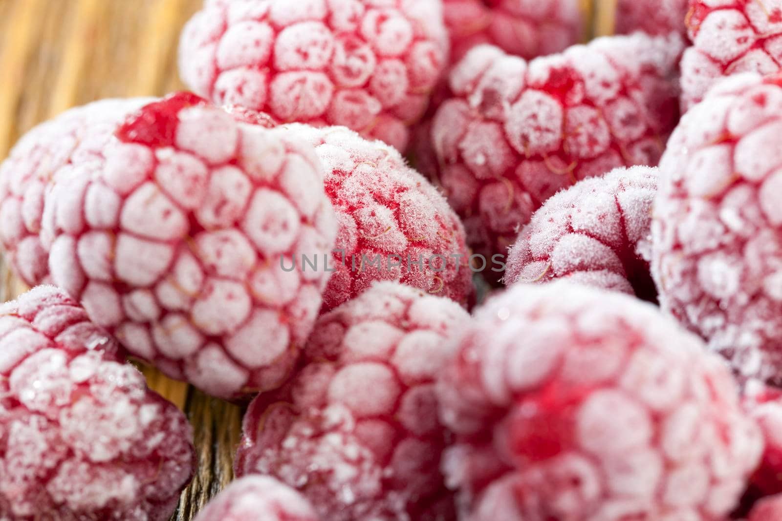 covered with frost ripe red raspberries during cooking, close-up